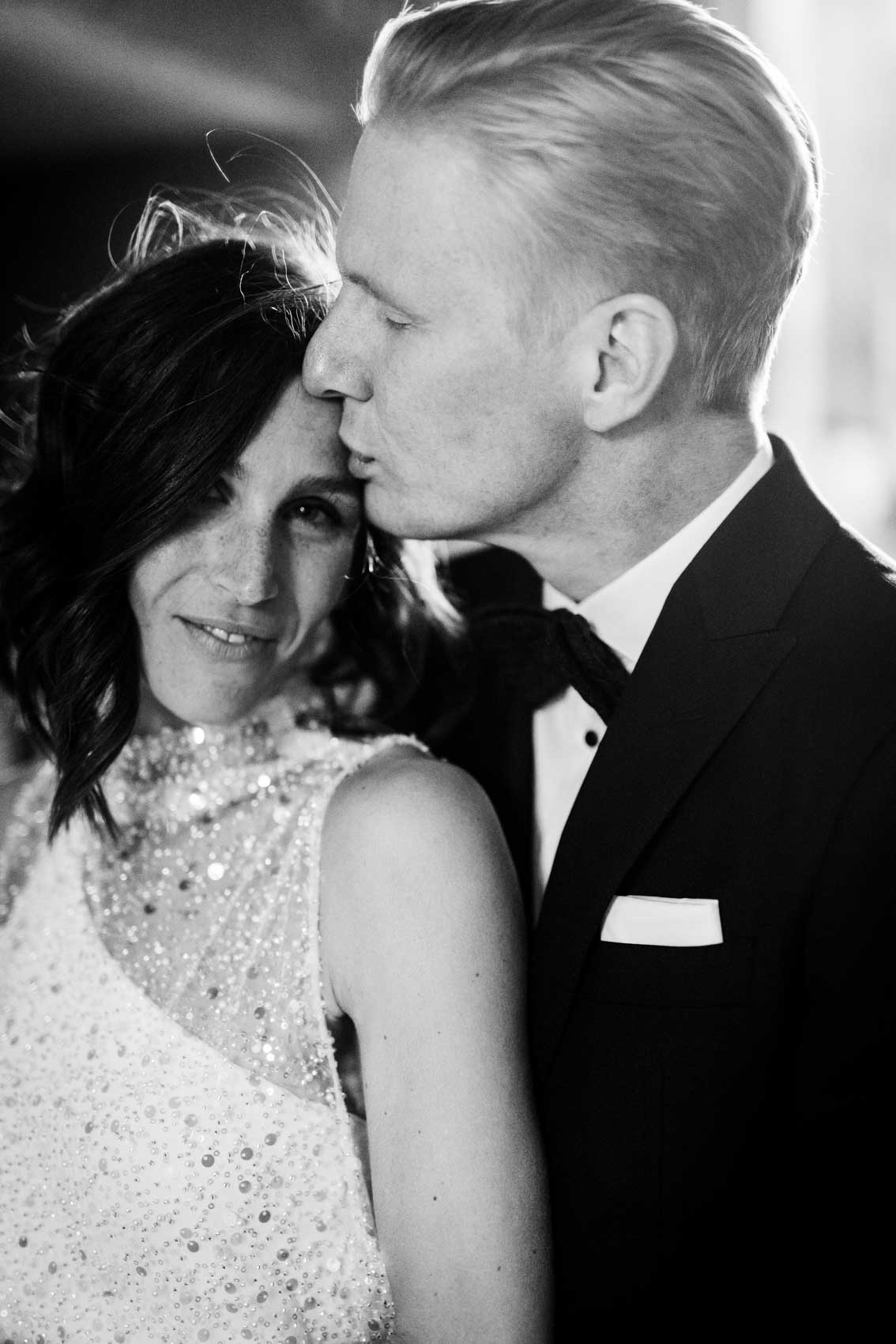 Bräutigam küsst Braut sanft auf die Stirn bei Hochzeit im Factory Hotel Münster